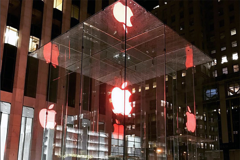 photo of Apple dresses up stores with red logos, employees wear red shirts for World AIDS Day image