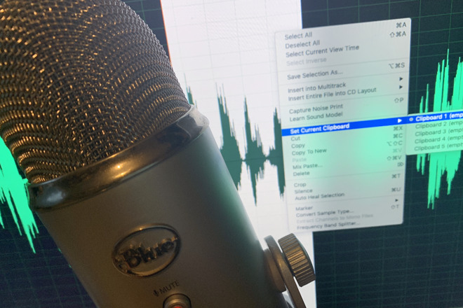 Blue Yeti microphone in front of Adobe Audition during an editing session