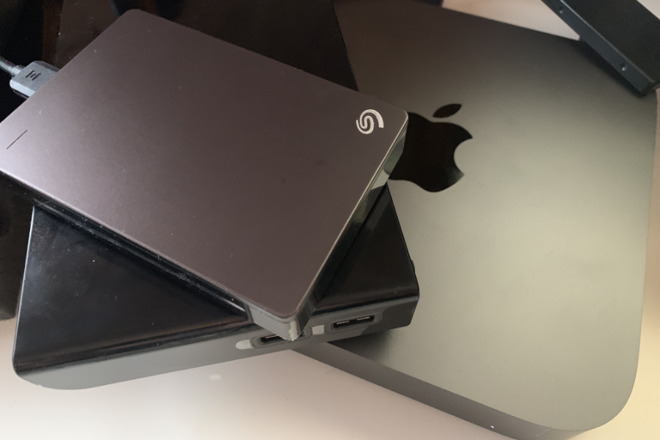 A bundle of external drives atop a Mac mini