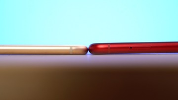 Showing the thickness of the two iPhone models.