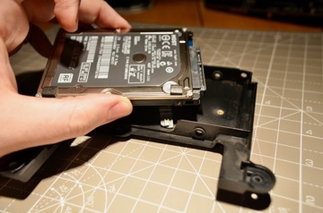 A few screws holds the drive in the drive assembly