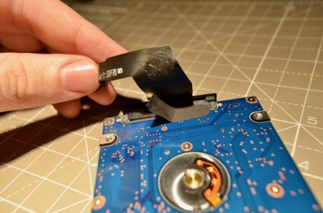 Apple added tape to keep the SATA connector in place on the drive