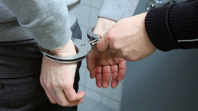 A man in handcuffs (image courtesy of Pixabay)