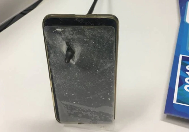 A close-up of the iPhone shows how far the arrowhead penetrated (via NSW Police)