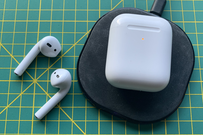 Apple's AirPods 2 with their wireless charging case on an Anker Qi charger