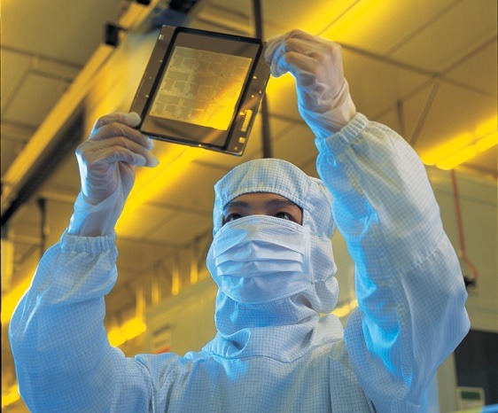 A TSMC worker in a clean room used for chip production (via Taiwan Semiconductor Manufacturing Co., Ltd.)