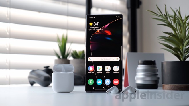 Samsung Galaxy Note 10+ next to Apple's AIrPods 2