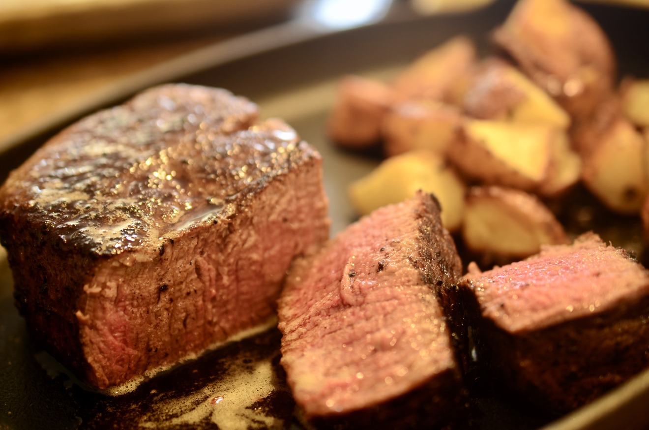 A steak cooked sous-vide is mid-rare in its entirety with a charred exterior