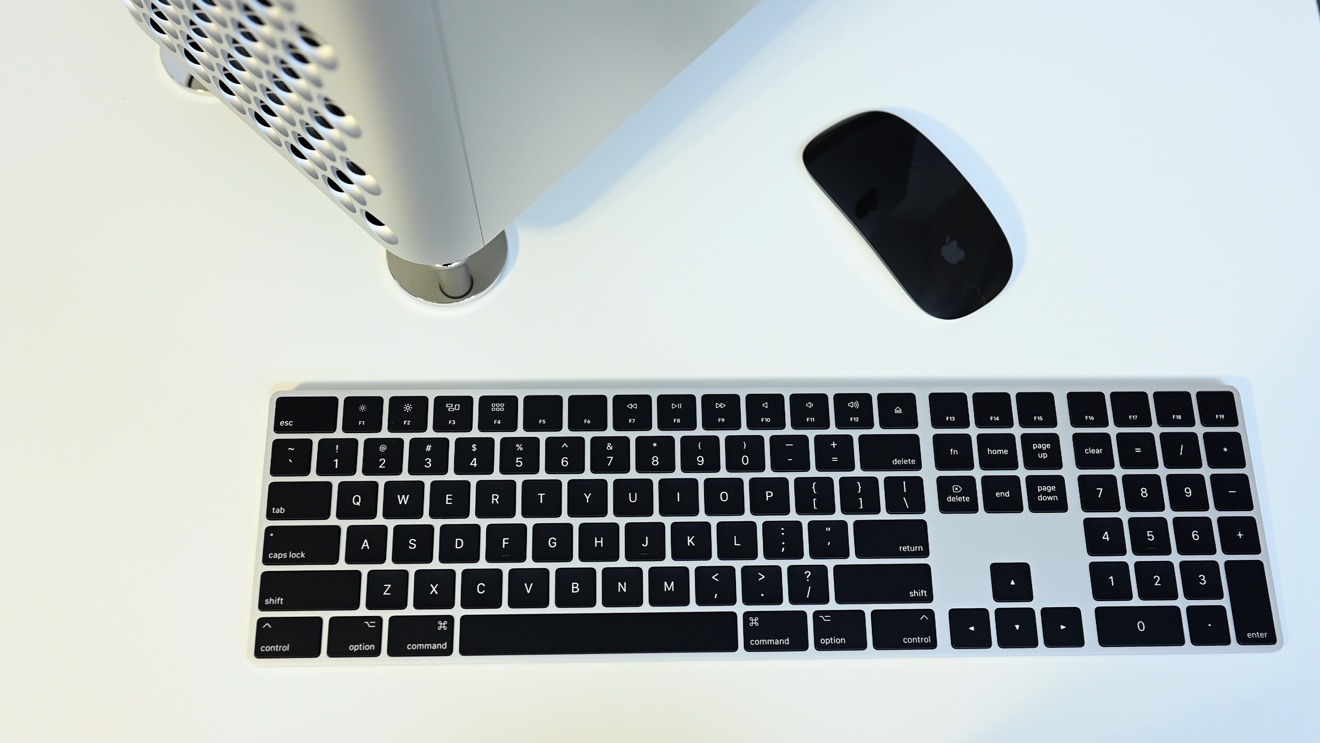 The Mac Pro ships with black Apple accessories including the Magic Keyboard, Magic Mouse, Magic Trackpad 2