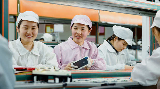 Line operators at an iPhone production facility in China, photographed in 2018. (Source: Apple)