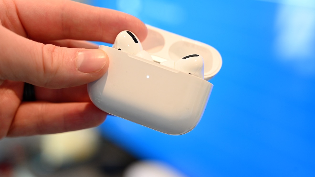 Hold the button on the back of a set of AirPods to put them into pairing mode
