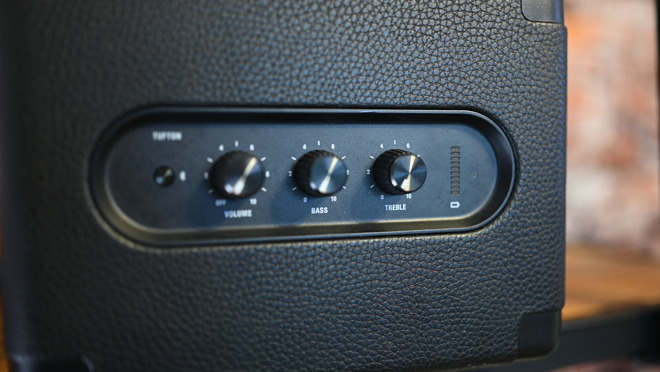 Three physical knobs are used to control volume, treble, and bass