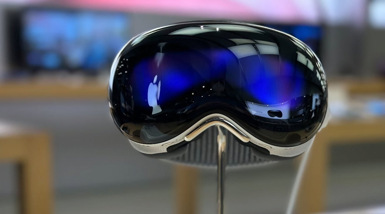 Futuristic VR headset with a sleek, reflective black visor, displaying a glowing Apple logo, resting on a stand in a blurred background of a technology store.