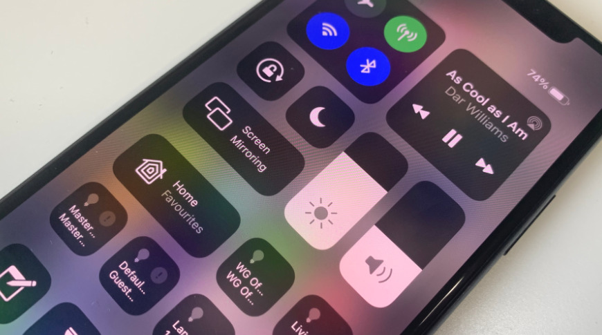 You can rearrange some Control Center controls to put the flashlight where you want