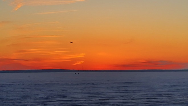 DJI FPV drone as a silhouette at sunset