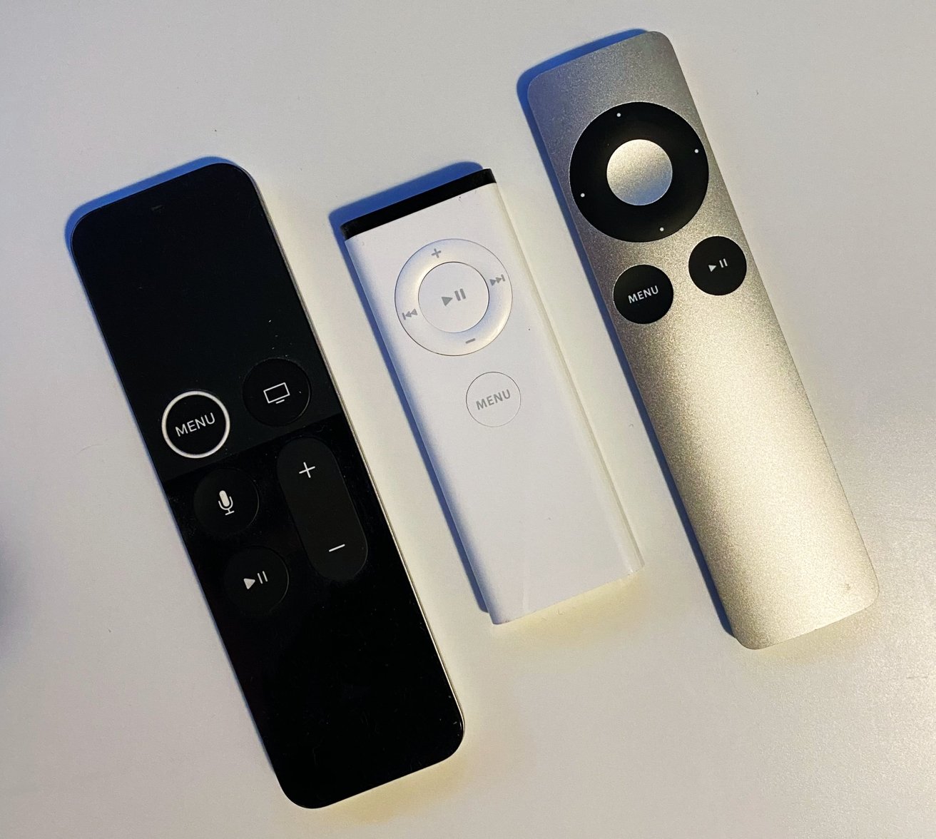 The refreshed first-generation Siri Remote (left), the first Apple Remote (middle), the second Apple Remote (right)