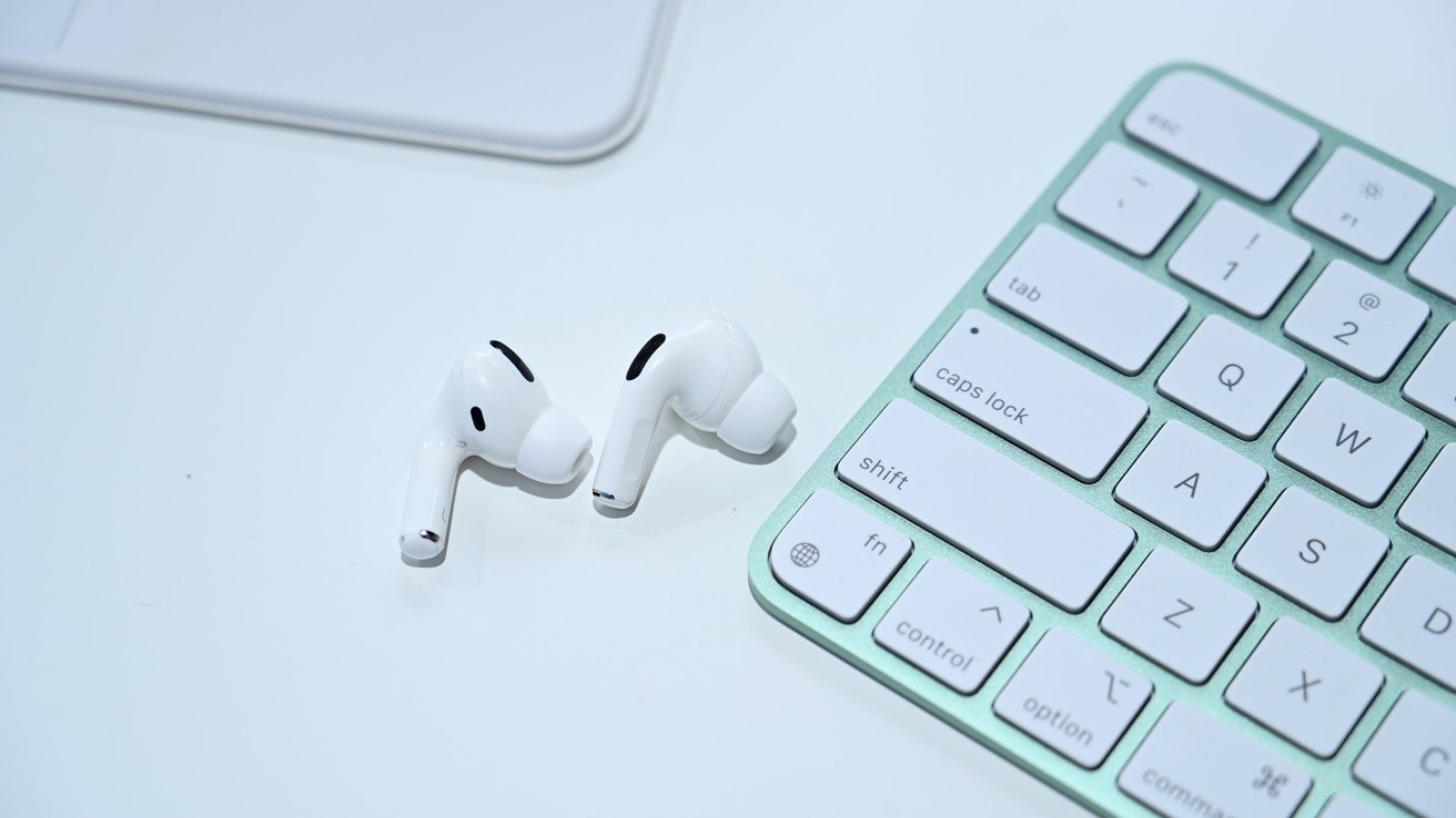 AirPods Pro next to the new iMac keyboard
