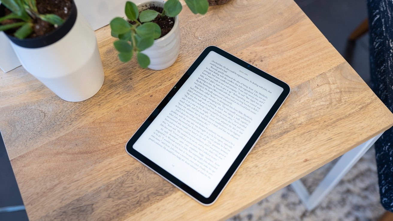 iPad mini on wood table with plants