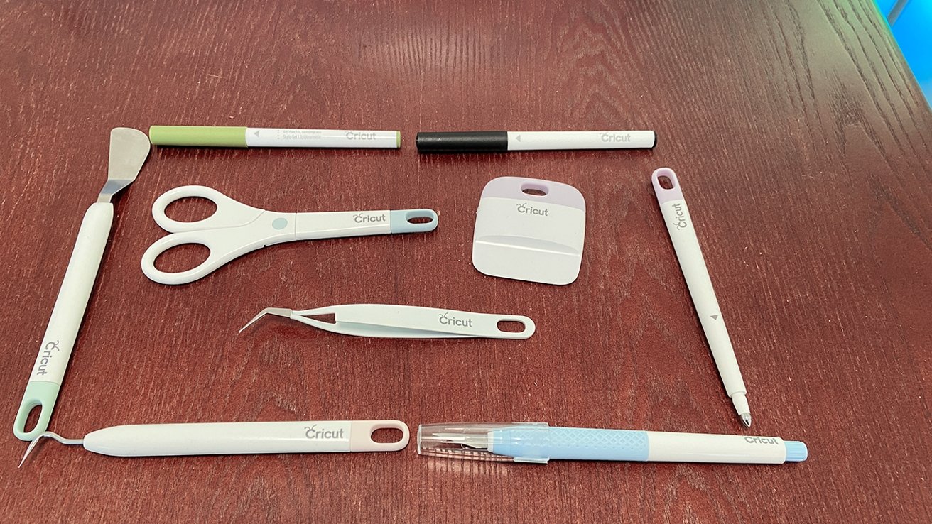 Cricut pens, weeder tools, scrapers, and a Cricut-branded craft knife