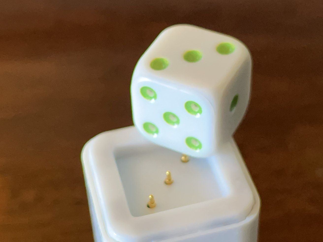 Charging is done by pressing the five face of the dice onto the charging base