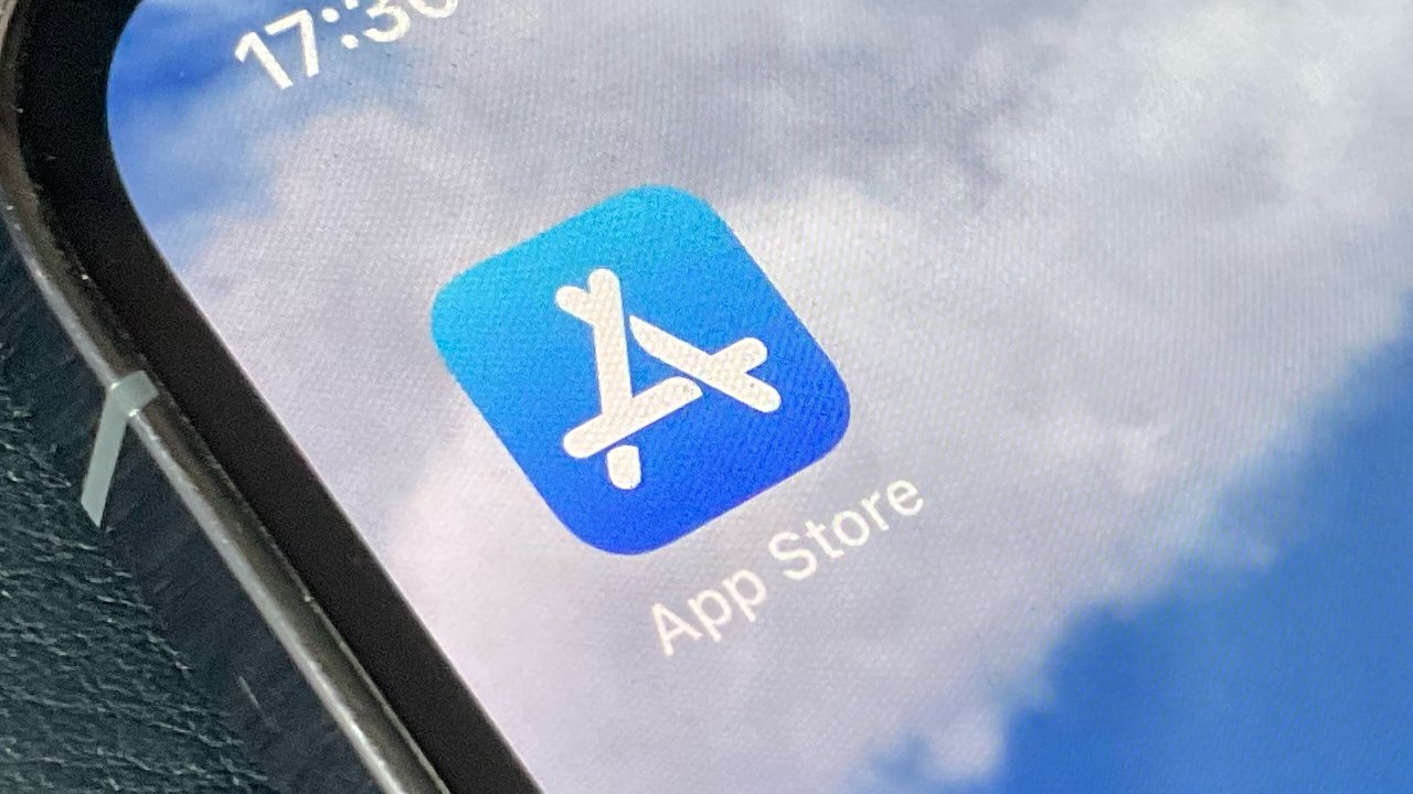 Apple's App Store logo on the front left of an iPhone's screen