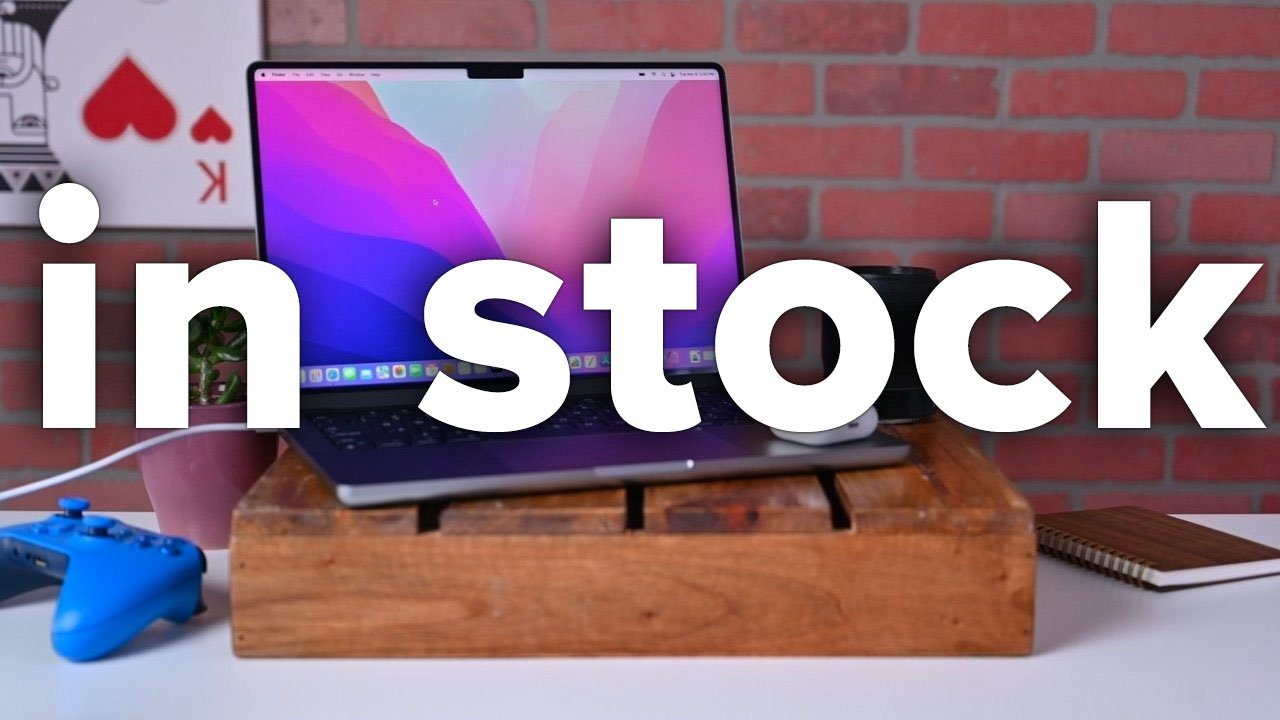 14-inch MacBook Pro on desk with in stock bold text