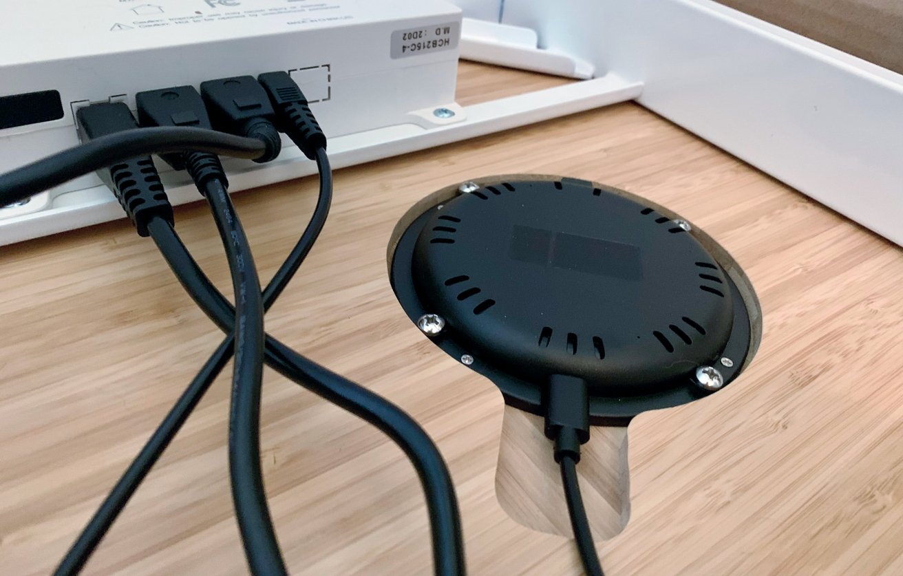 The wireless charger is built into a cut-out section underneath the desk. 