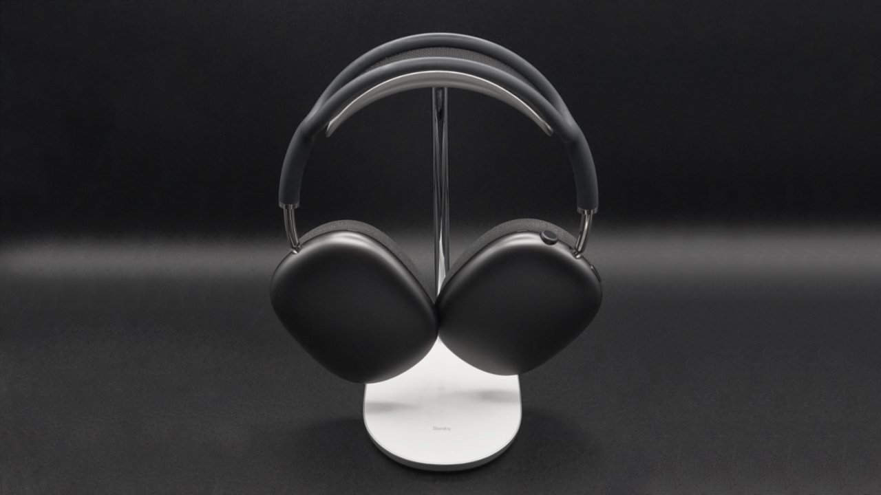 The AirPods Max are held in a form fitting u-shaped arc