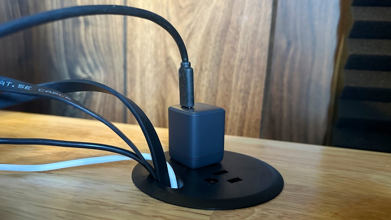 A power grommet adds two outlets to the top of the desk, ideal for powering accessories