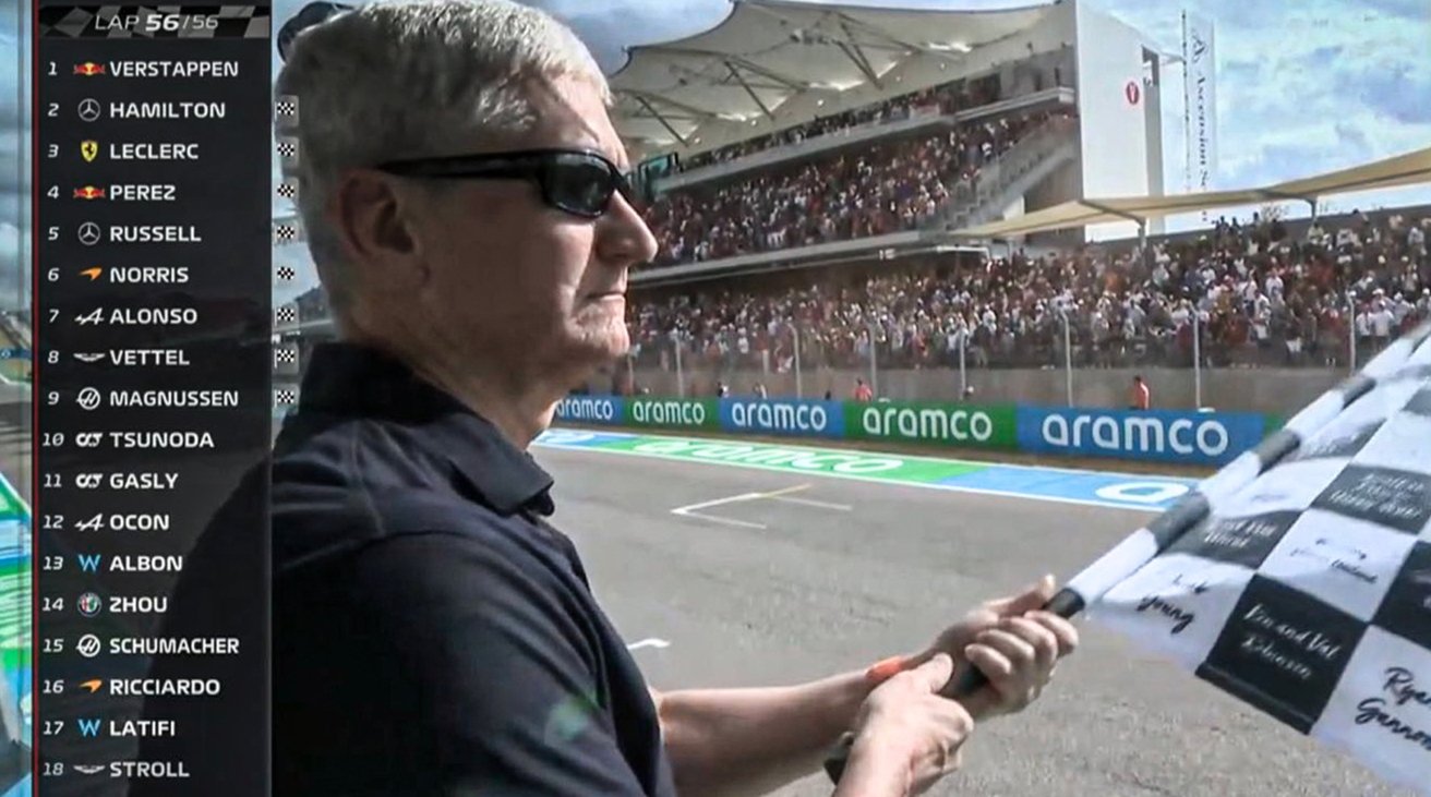 Tim Cook waving the checkered flag at the U.S. Grand Prix.