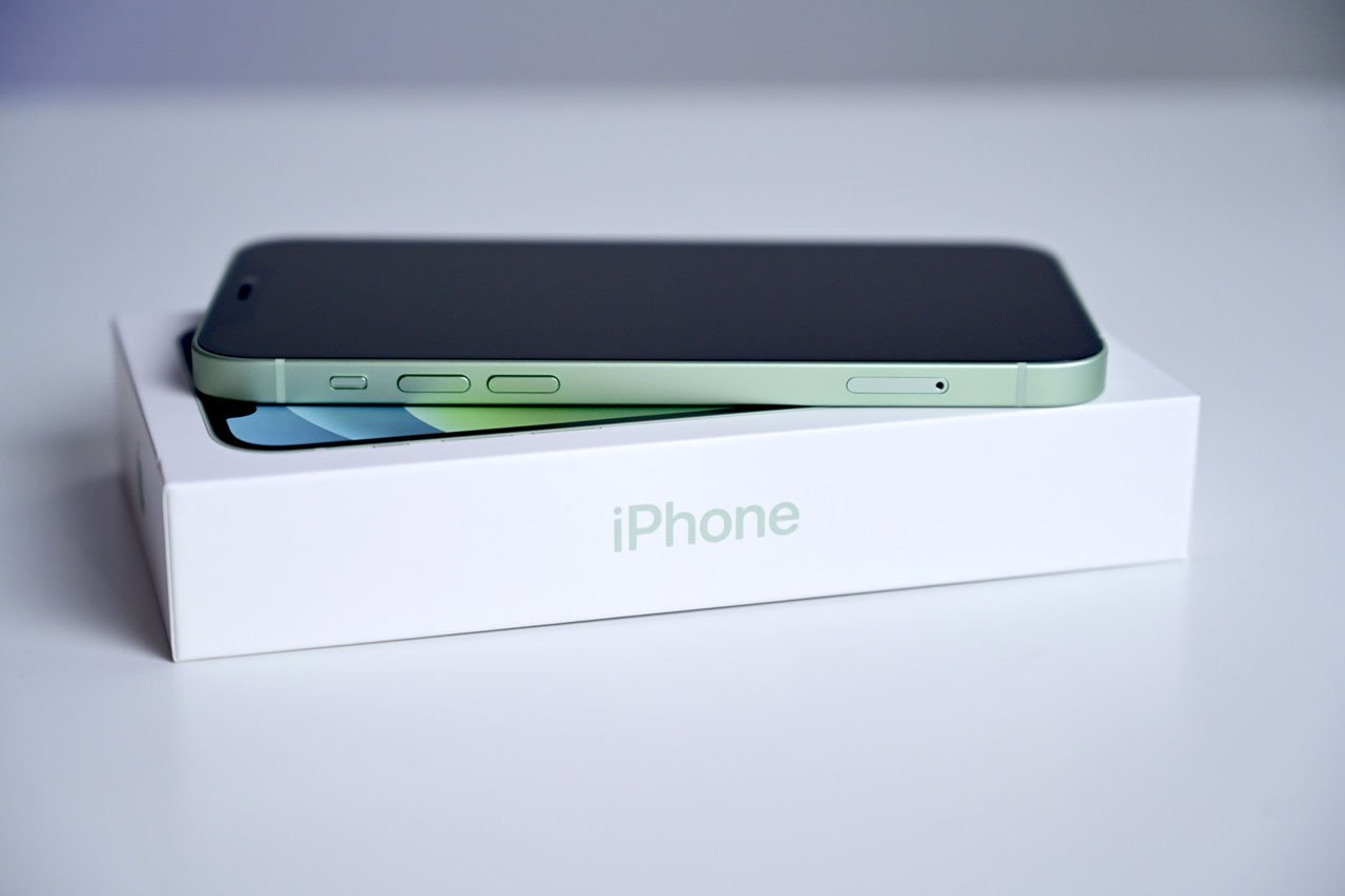 Refurbished unlocked iPhones are an excellent way to save money | Green iPhone 12 on top of box