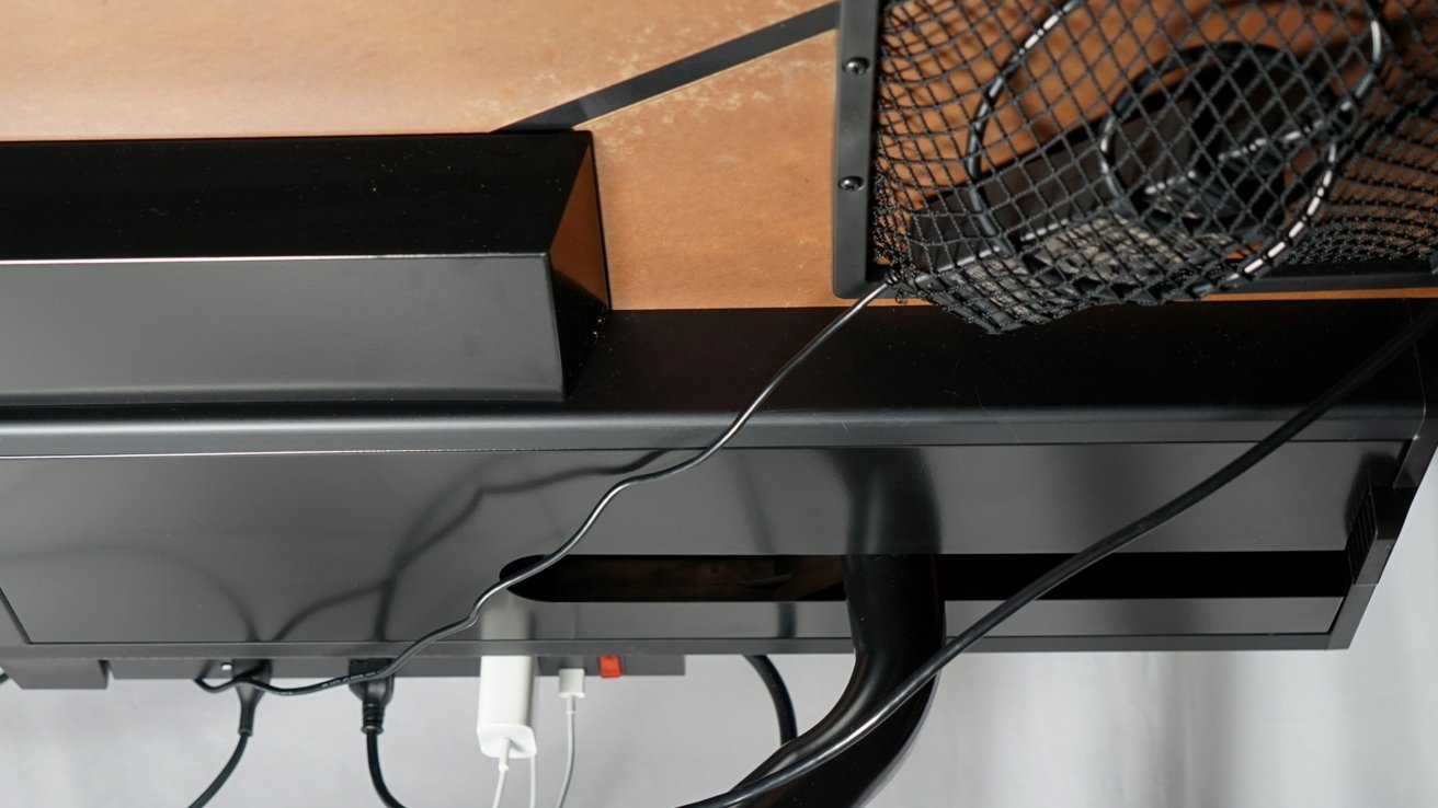 Netting in the bottom of the desk provides some storage for cables or power supplies