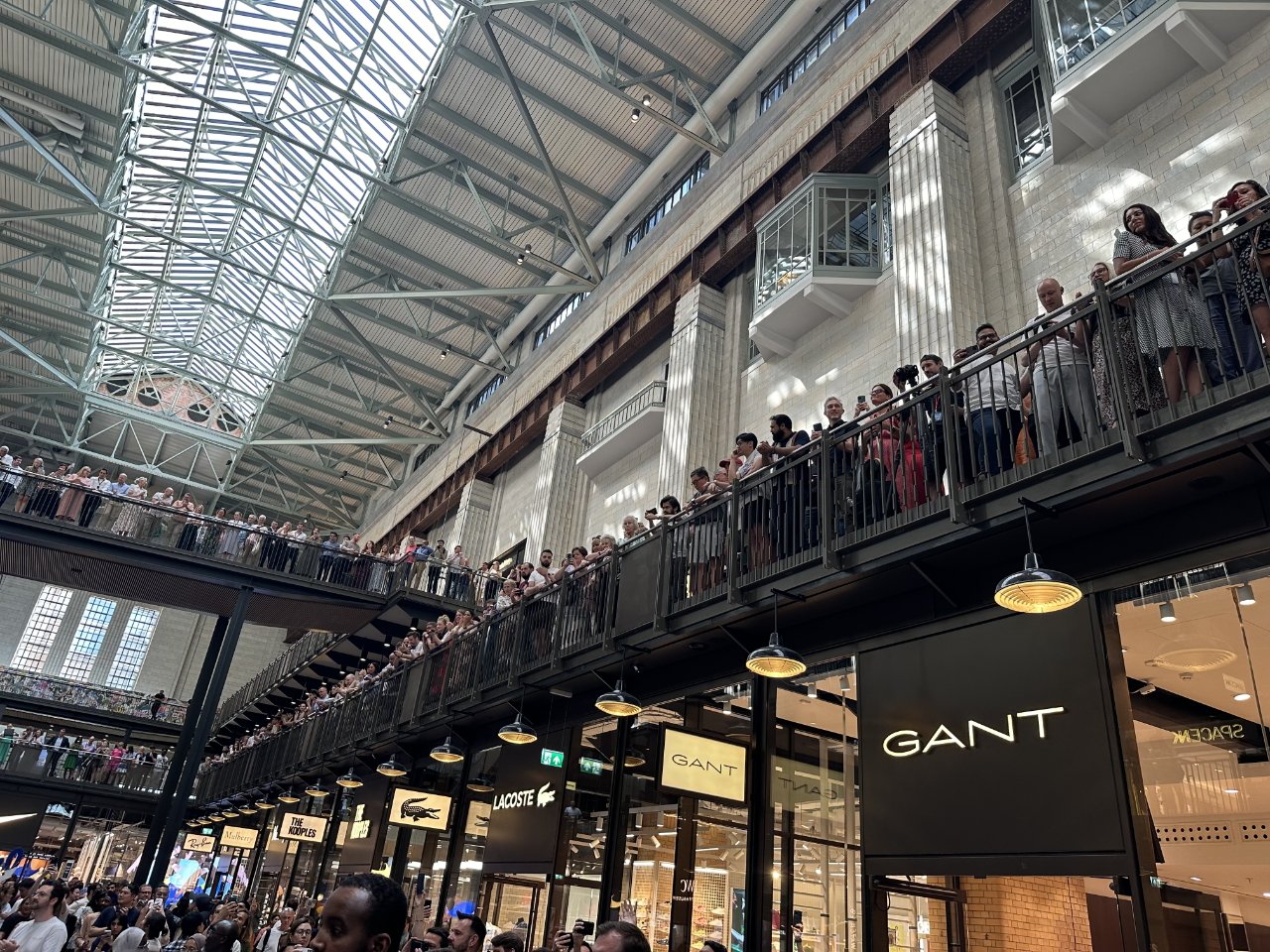 Hundreds line the balcony opposite Apple Battersea ahead of its opening (Source: Craig Jobbins)