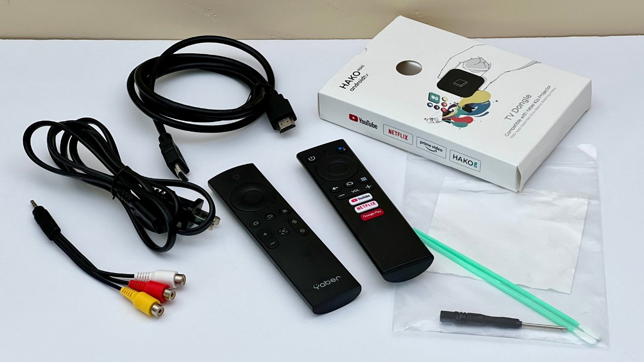 The Yaber K2s projector came with a power cord, a remote control for the projector, and one for the TV dongle, a 3-in-one AV cable, an HDMI cable, and a basic cleaning kit. 