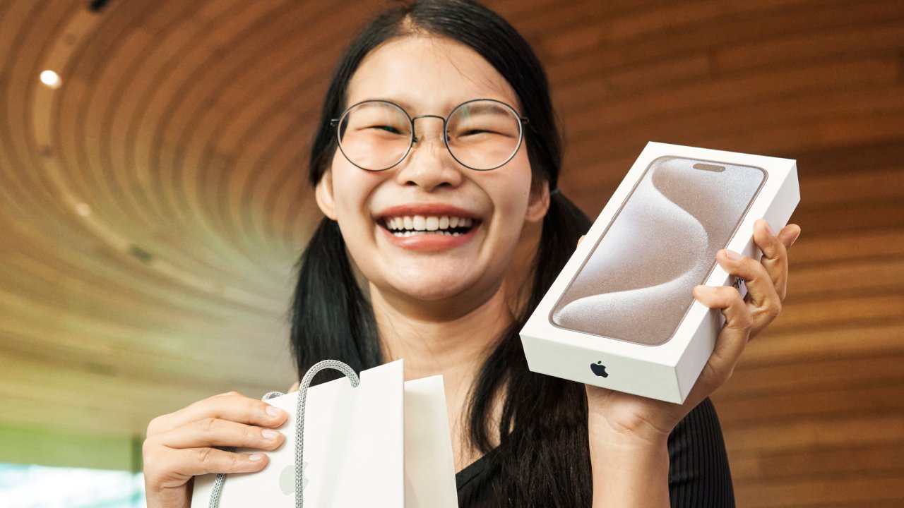 A woman with her new iPhone 15 Pro Max in Apple Central World, Bangkok