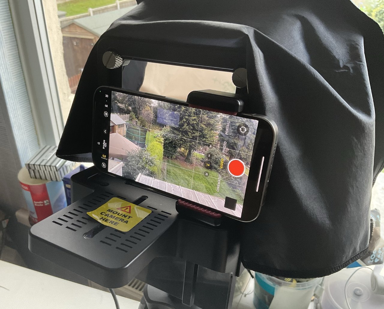 The black cloth at the top is a shroud that normally you pull back down over the camera. It prevents light getting in to the device and reflecting back into the lens.