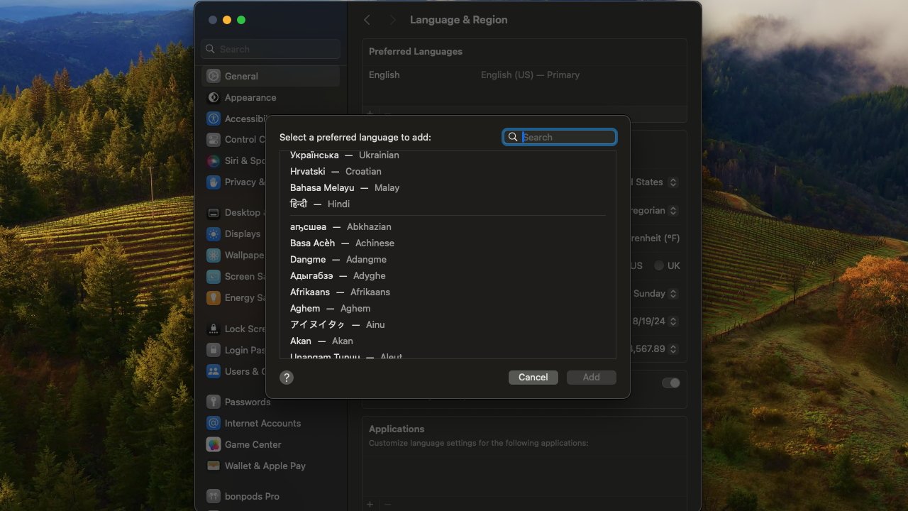 The Language and Region settings asking for a choice on language, all put over the macOS Sonoma background