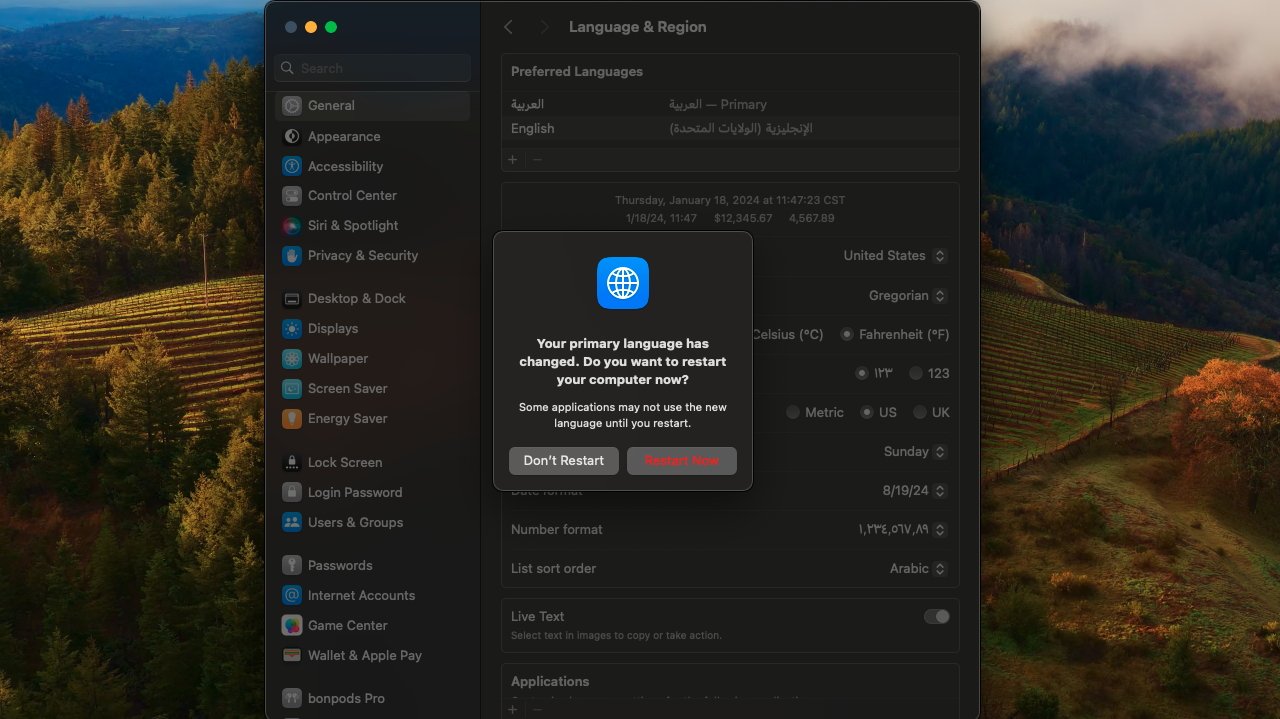 The Language & Region menu prompting for a restart after adding a new language, all of which is over the macOS Sonoma background