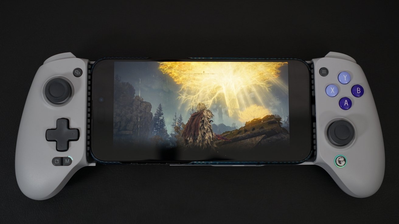 iPhone in GameSir controller with a scene from PS5 game 'Elden Ring' shown with a bright glowing tree in the background.