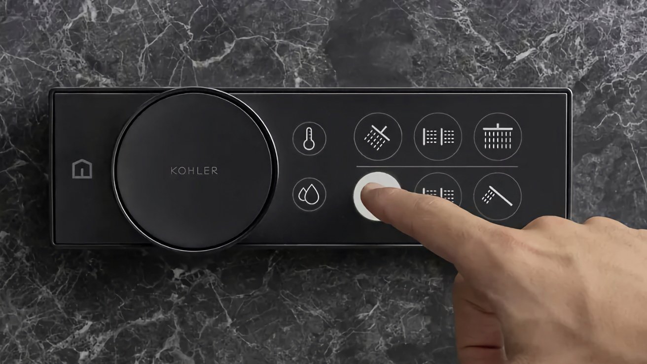 A finger presses a button on a sleek, digital shower control panel with multiple icons representing different functions, mounted on a marble wall.