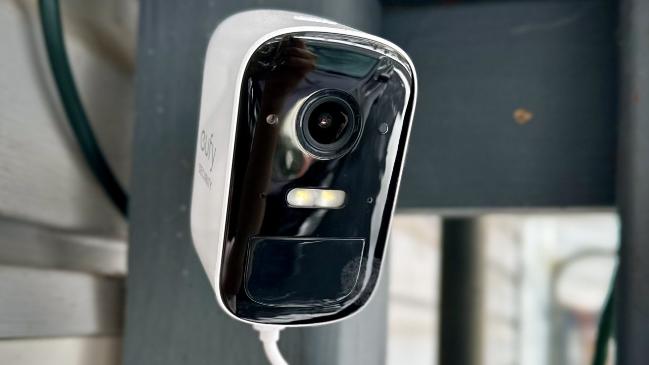 A close up of the Eufy camera showcasing the camera and spotlight with a blurred dark background