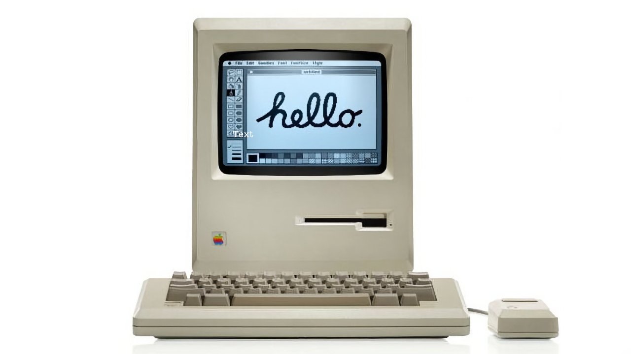A vintage original Macintosh computer with a beige casing, featuring a built-in screen displaying the word