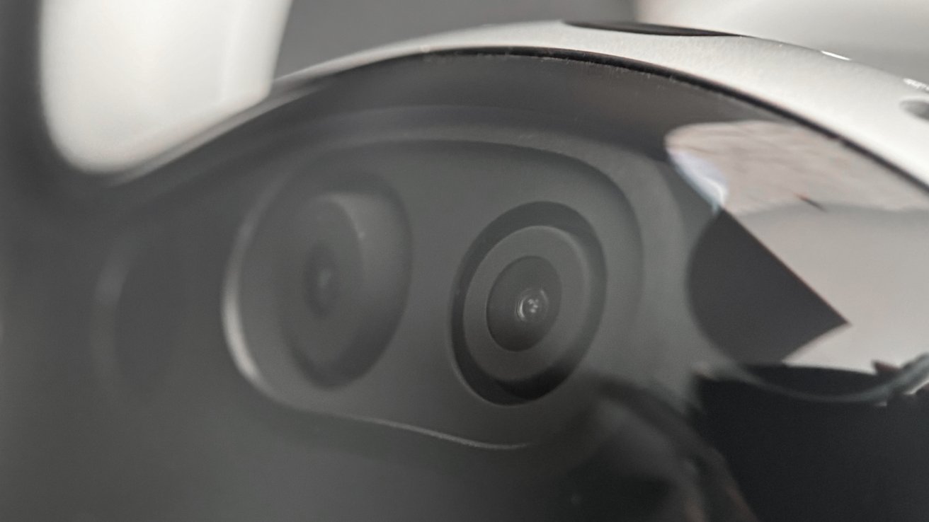 Apple Vision Pro upside down with two cameras visible behind the display glass and a hand tracking sensor visible at the top