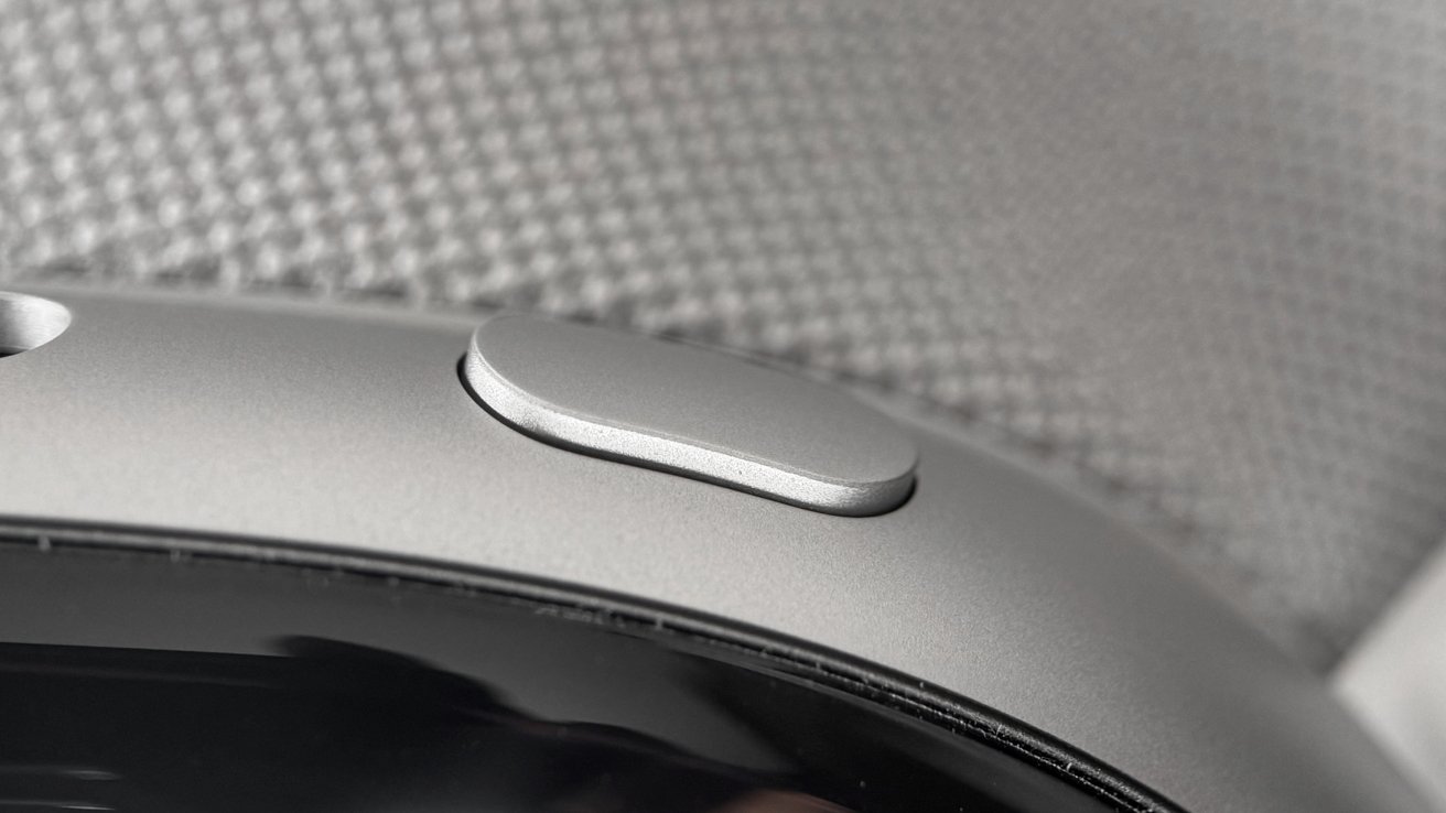 A button is visible on the top of the Vision Pro, it sticks out slightly and is oval in shape