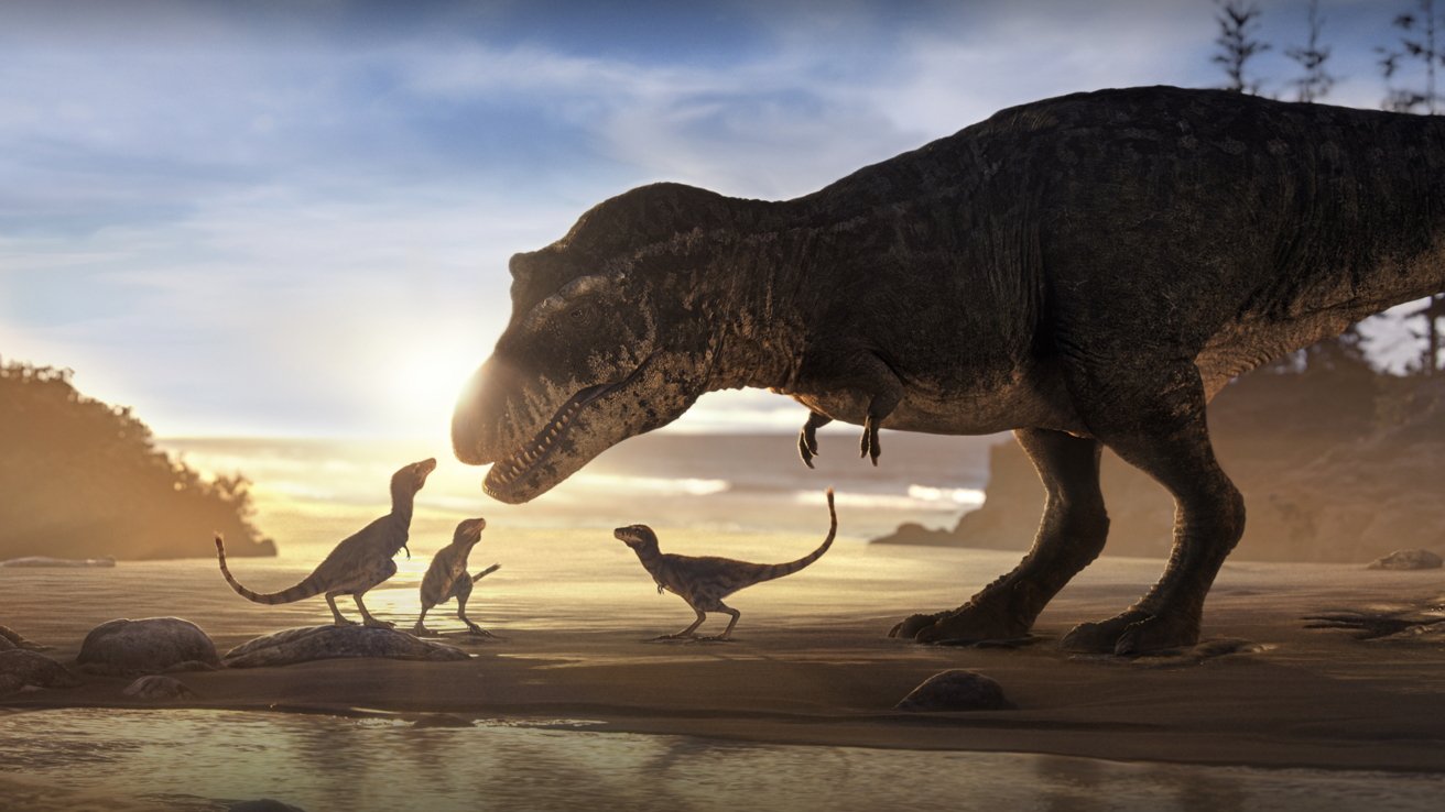 A large tyrannosaurus rex stands beside three smaller dinosaurs on a beach at sunset.