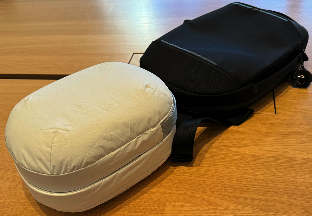 The giant Apple Vision Pro bag next to a normal-sized backpack
