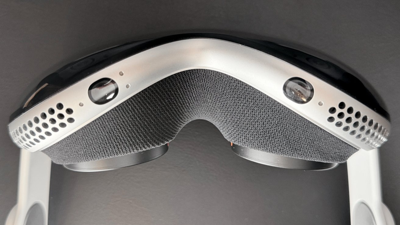 A view of Apple Vision Pro flipped upside down. The hand tracking sensors are visible with the eye inserts jutting out from the interior.