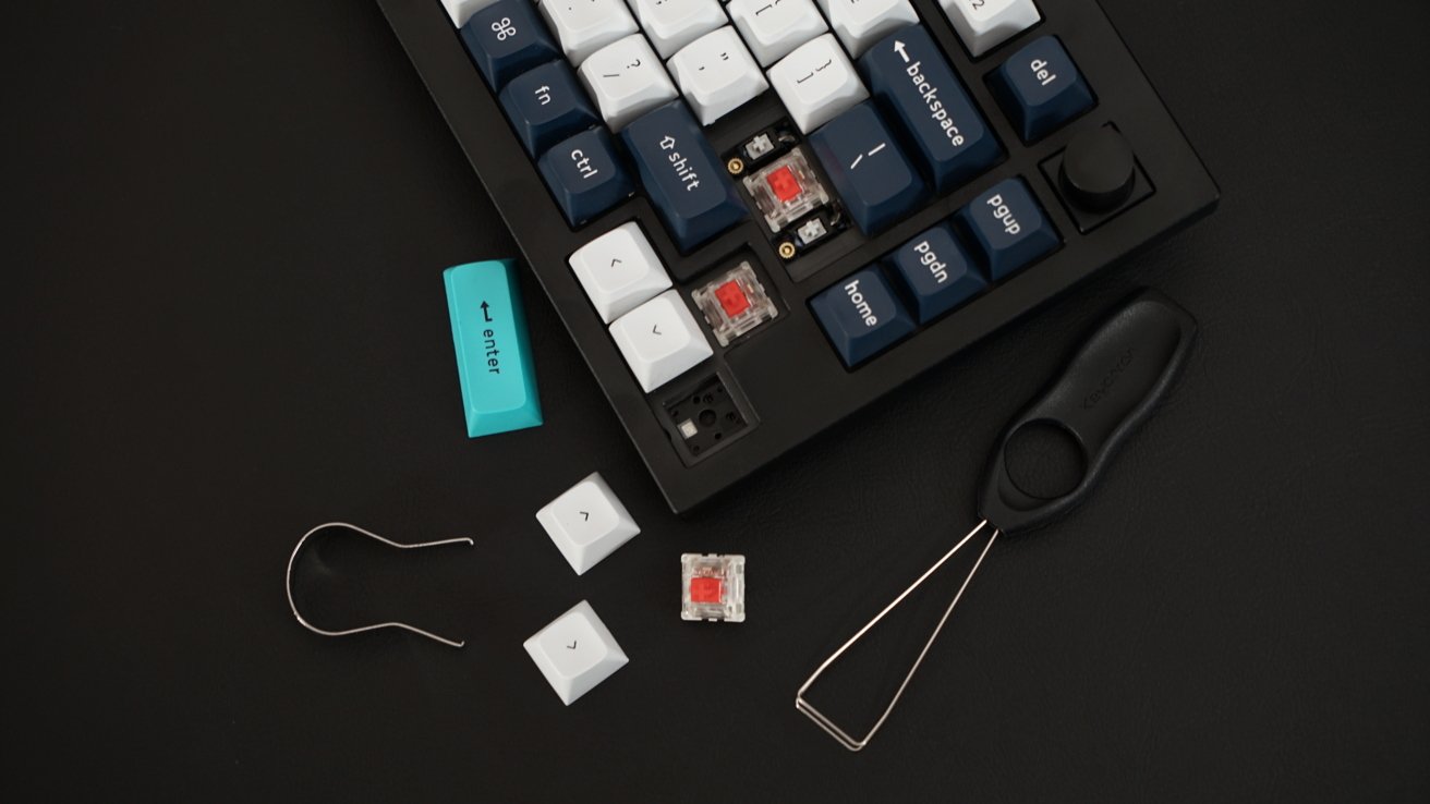A mechanical keyboard with a few keycaps removed and a switch removed.