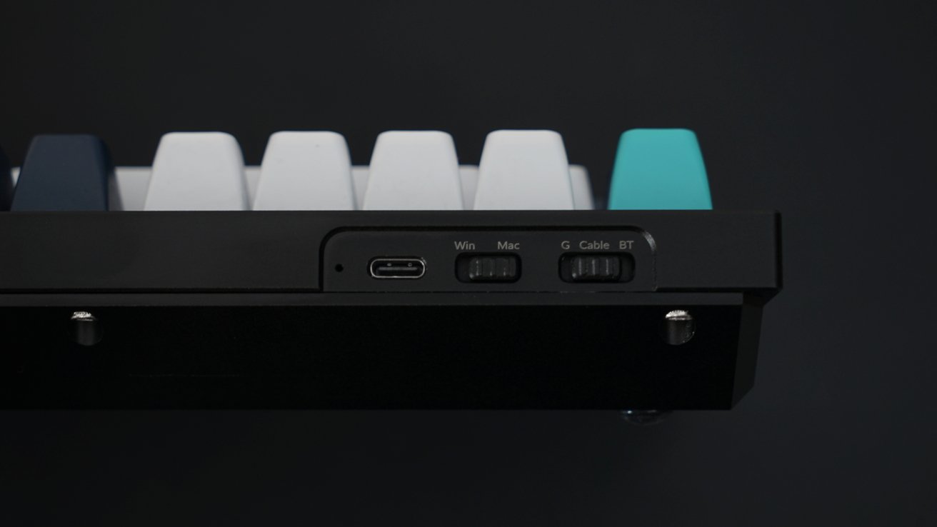 The rear of the Keychron mechanical keyboard showing switches for 2.4GHz, cable, or Bluetooth on one switch. A switch for Windows and Mac as well.