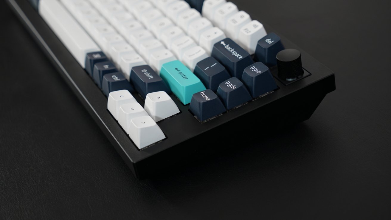 The arrow keys are in focus on the mechanical keyboard